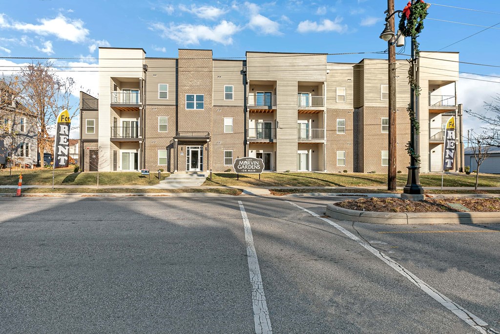 an empty street in front of an apartment building