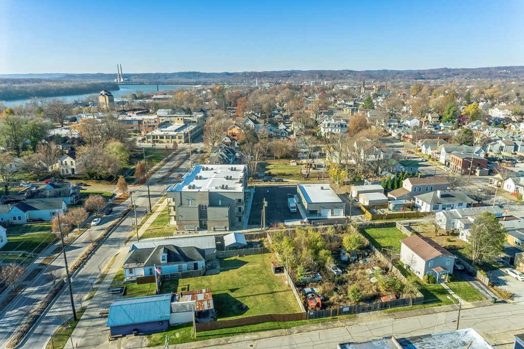 an aerial view of a neighborhood with houses and a body of water