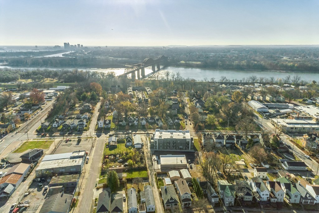 an aerial view of a city with a river and a bridge