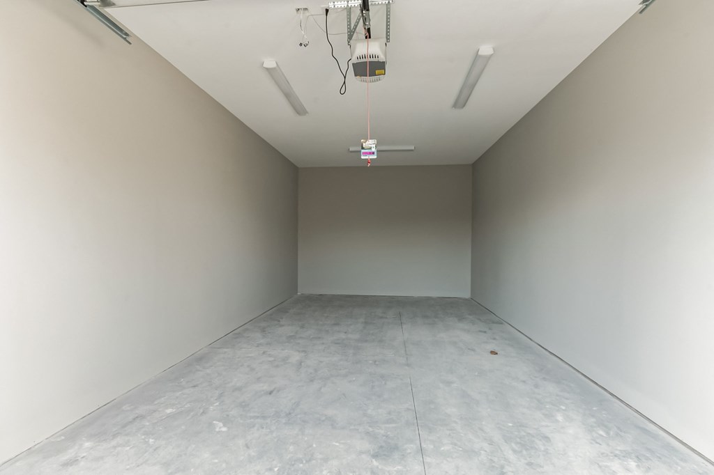 an empty room with white walls and a grey floor