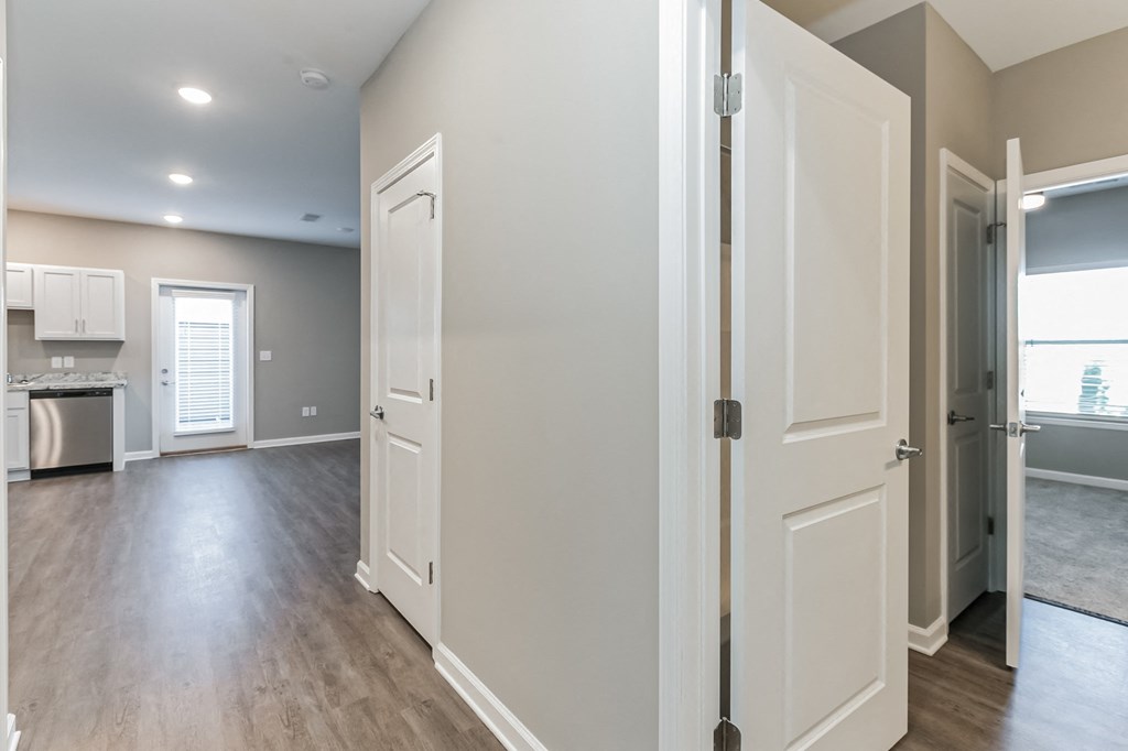 an open kitchen and living room with white doors