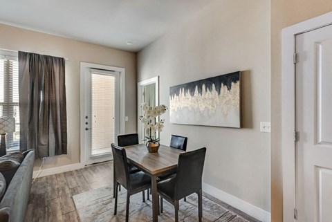 a dining room with a table and chairs and a window