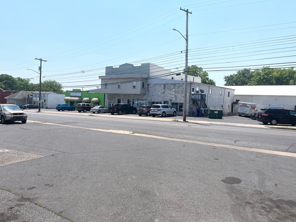 a building with cars parked in front of it on a street