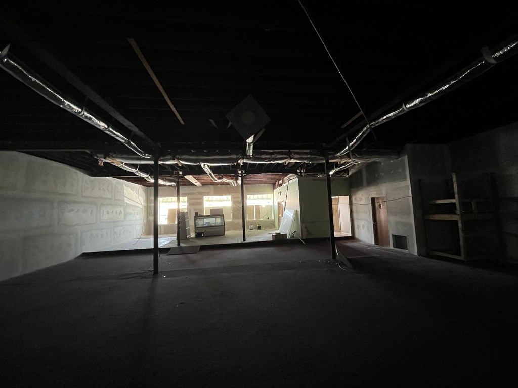 an empty room in a building with pillars