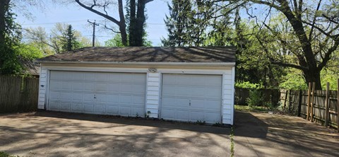 a small white garage with a white garage door