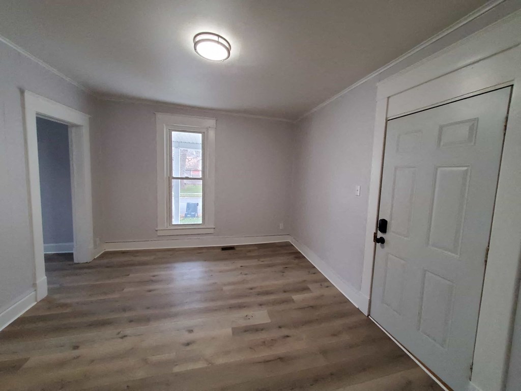 a living room with white walls and a white door