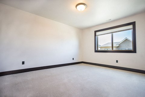a empty room with a window and a white carpet