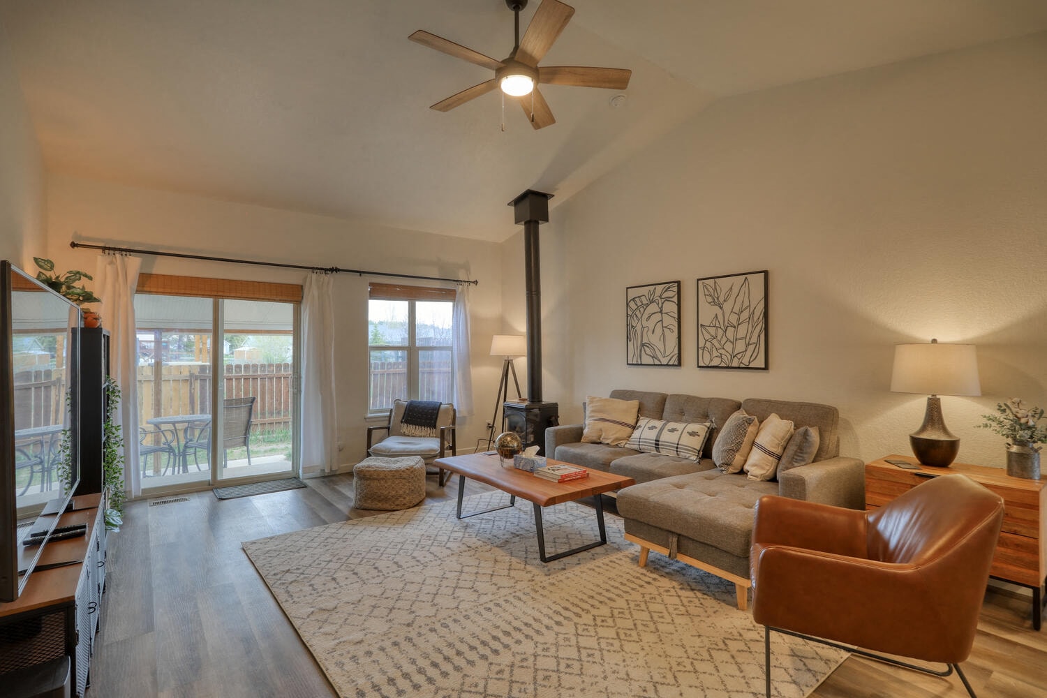 a living room with a couch and a ceiling fan
