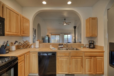a kitchen with wooden cabinets and a dishwasher and a sink