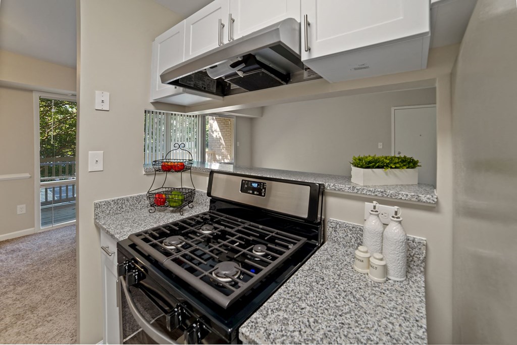a kitchen with granite counter tops and a stove top oven