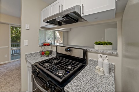 a kitchen with granite counter tops and a stove top oven