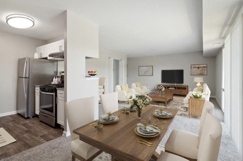 a dining room and living room with a table and chairs