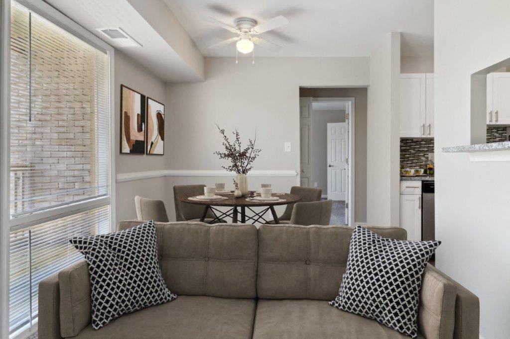 a living room with a couch and a dining room table