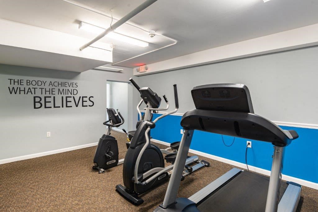 the gym is equipped with a treadmill and an exercise bike