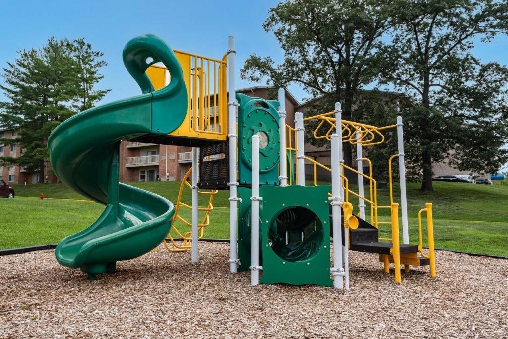 a playground with a slide and other toys in a park