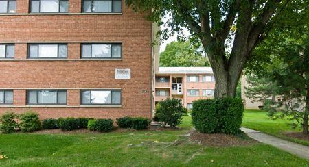 a brick building with a tree in front of it