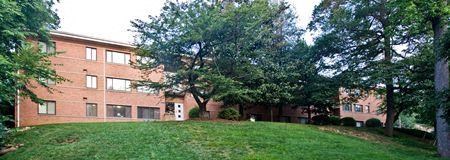 a large brick building with trees in front of it