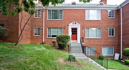 a red brick apartment building with a red door