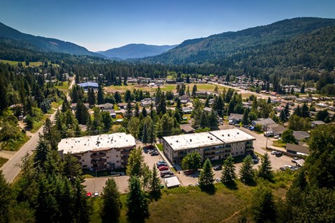 A small town with a large building in the center and a mountain in the background.