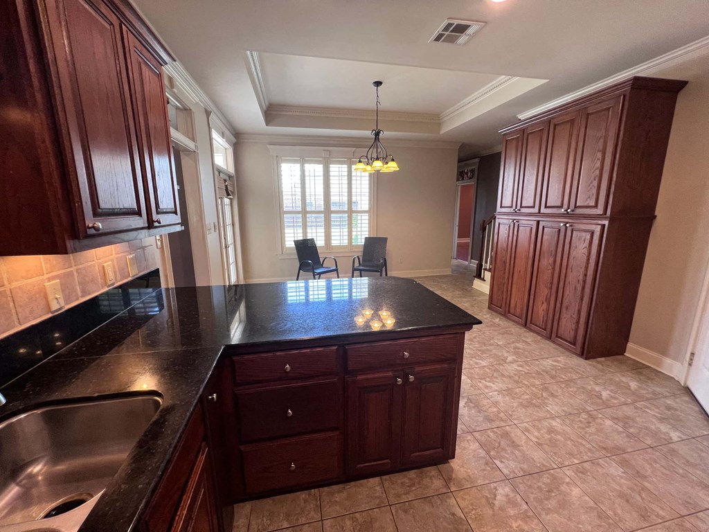 a large kitchen with a sink and a counter top