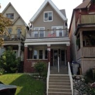 the front of a house with stairs in front of it