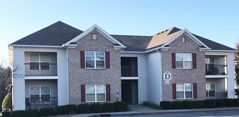 a brick house with a sidewalk in front of it