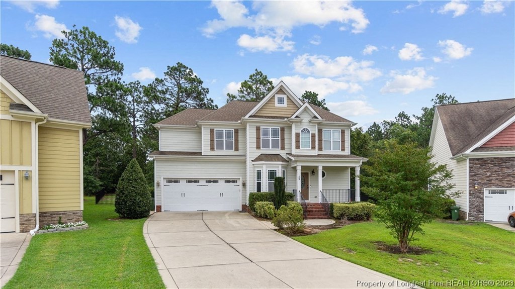 a white house with a garage and a driveway