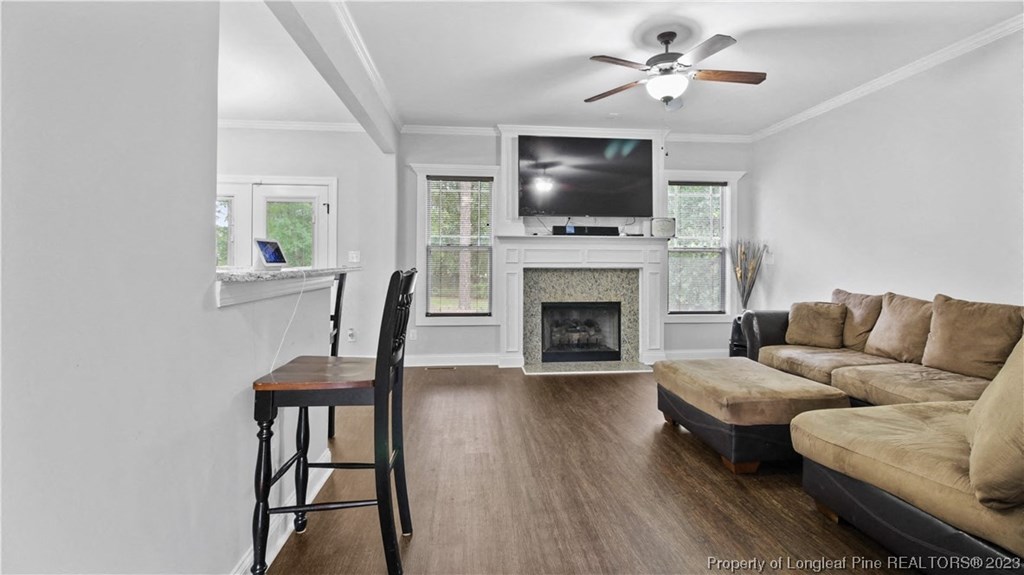 a living room with a couch and a chair and a television