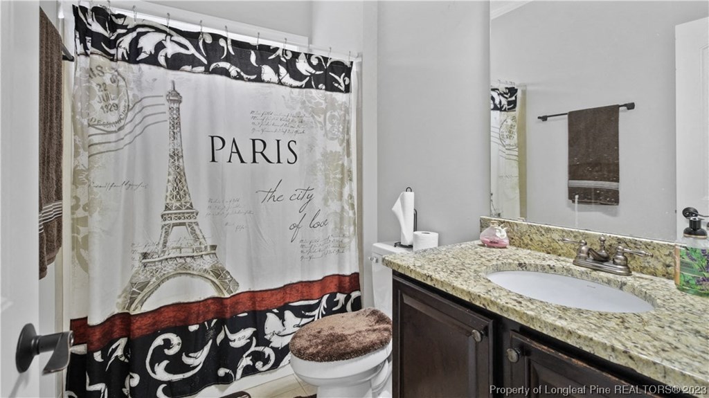 a bathroom with a shower curtain with the eiffel tower
