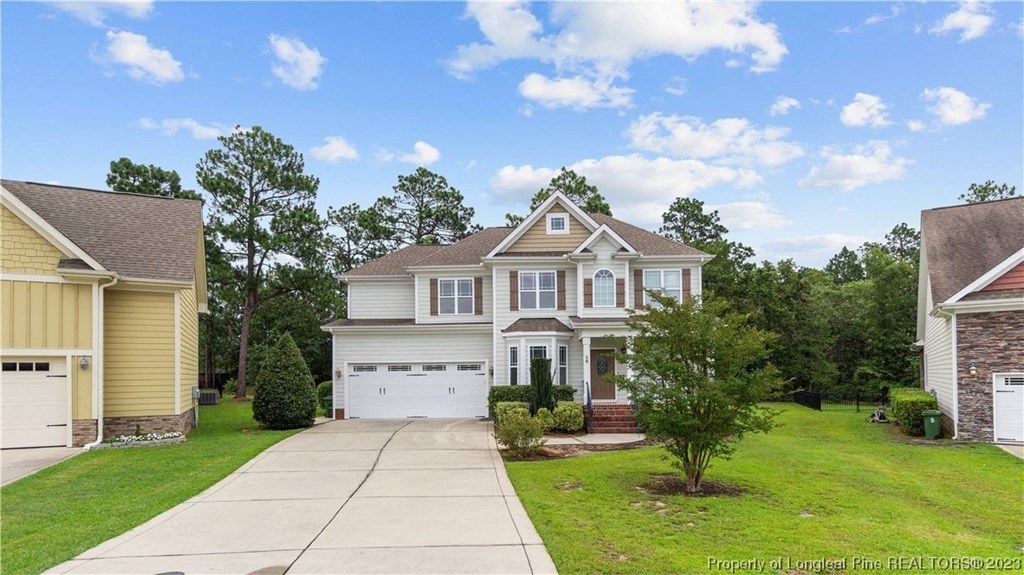 a house with a white garage door and a driveway
