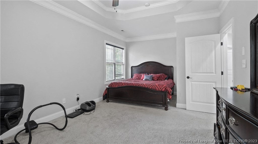 a bedroom with a bed and a dresser and a tv