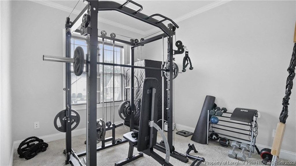 a home gym with weights and equipment in the corner of a room