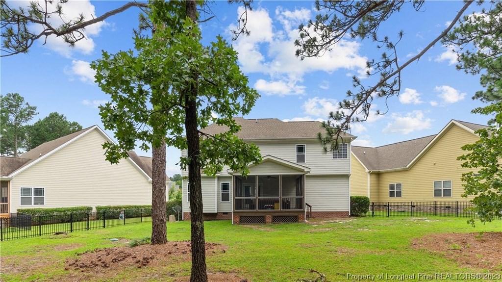 a home with a yard and two trees