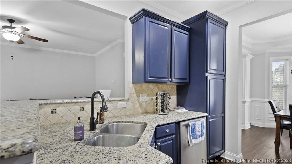 a kitchen with blue cabinets and granite counter tops