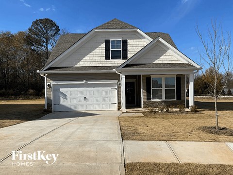a house with a white garage door and a driveway