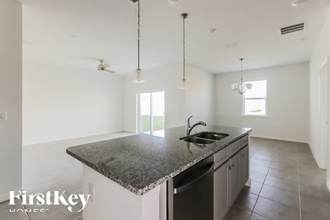 a large kitchen with granite counter tops and a sink