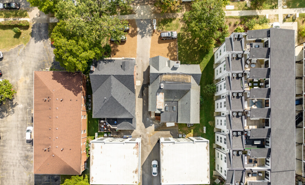a birds eye view of a neighborhood with houses and trees