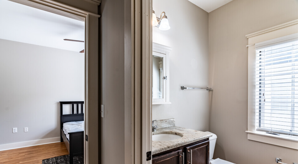 a view of a bathroom with a mirror and a sink