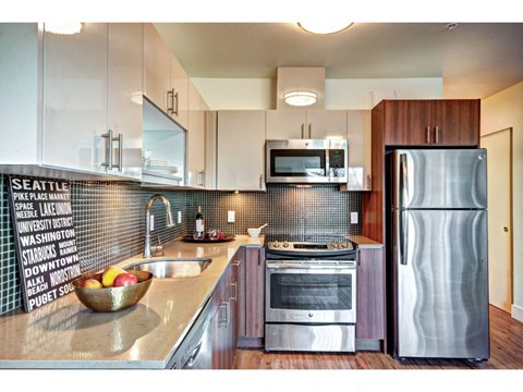 a kitchen with stainless steel appliances and white cabinets