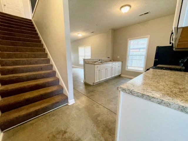 a kitchen with a staircase and a counter top in a house