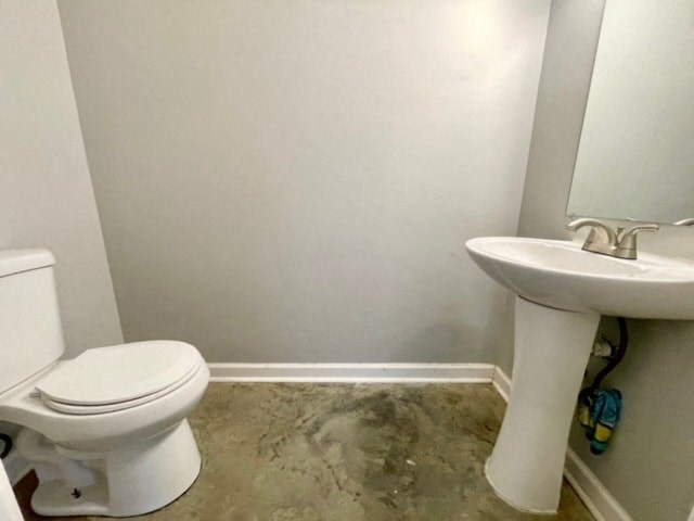 a white bathroom with a toilet and a sink