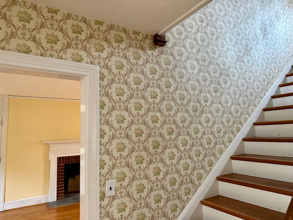 a stairwell in a house with wallpaper and stairs