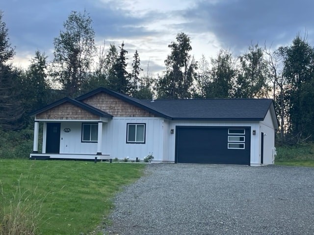 a white house with a driveway and a blue garage door
