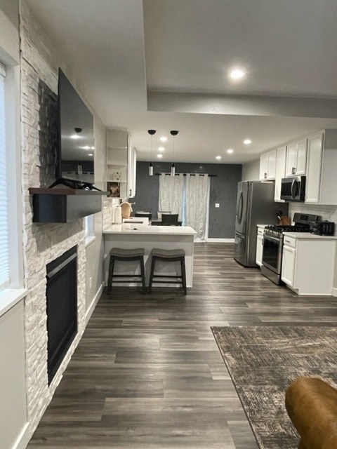 a kitchen and living room with a fireplace