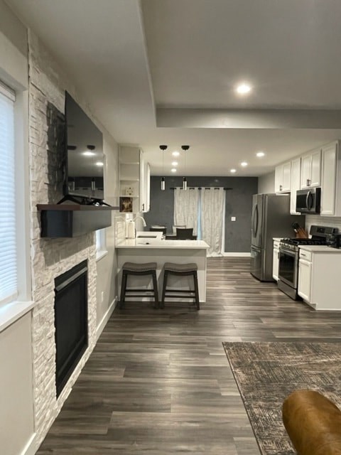 a kitchen and a living room with a fireplace