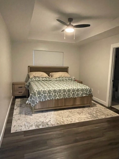 a bedroom with a bed and a ceiling fan