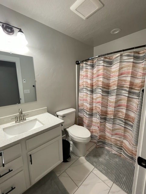 a bathroom with a toilet and a sink and a shower