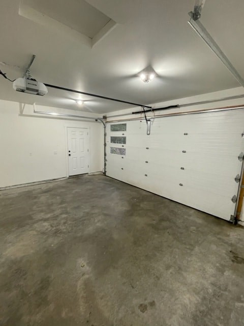the inside of a garage with a white wall and a door
