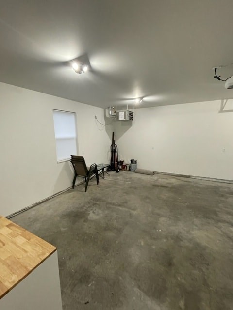 an empty room with a chair and a window in it