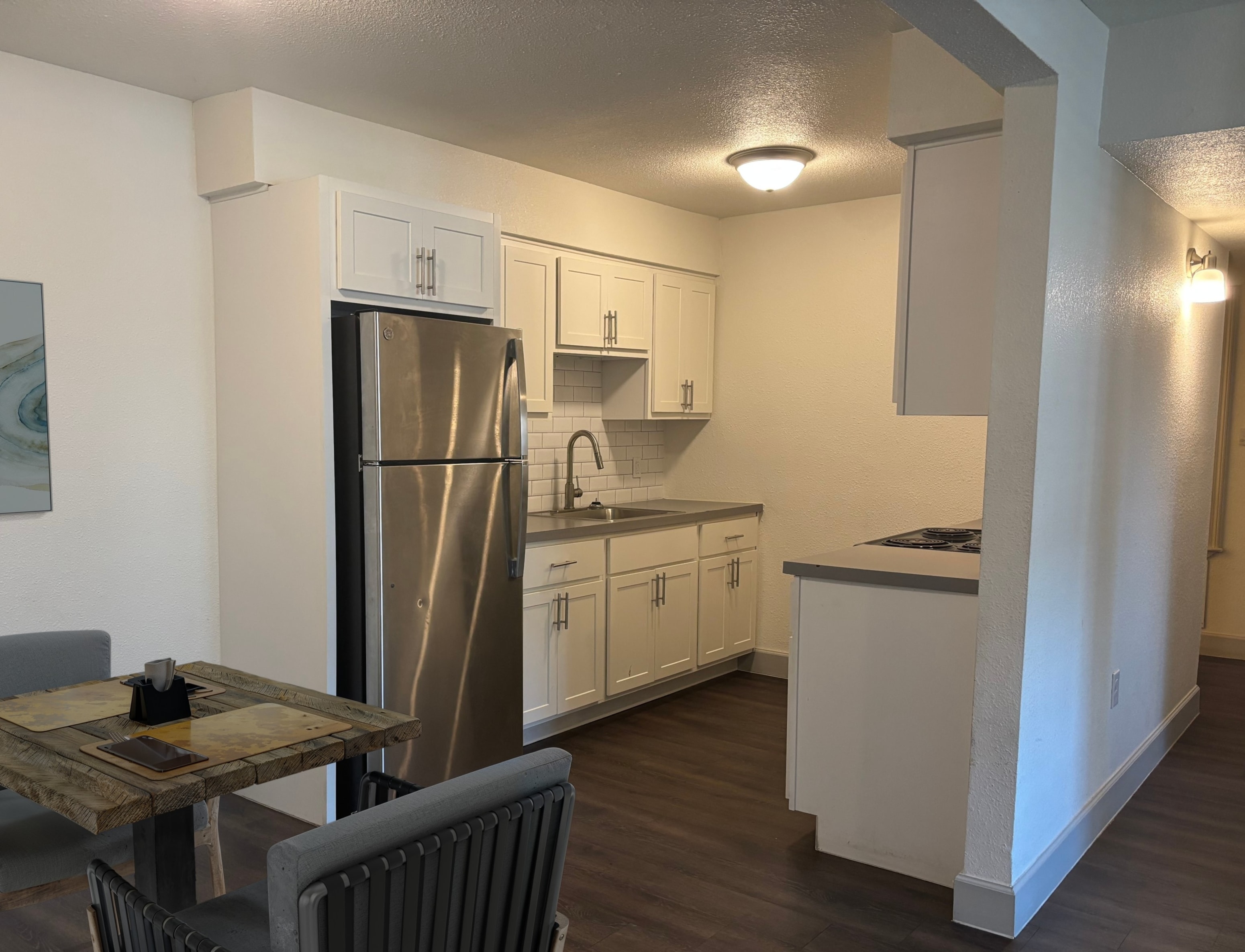 A kitchen with a table and chairs.